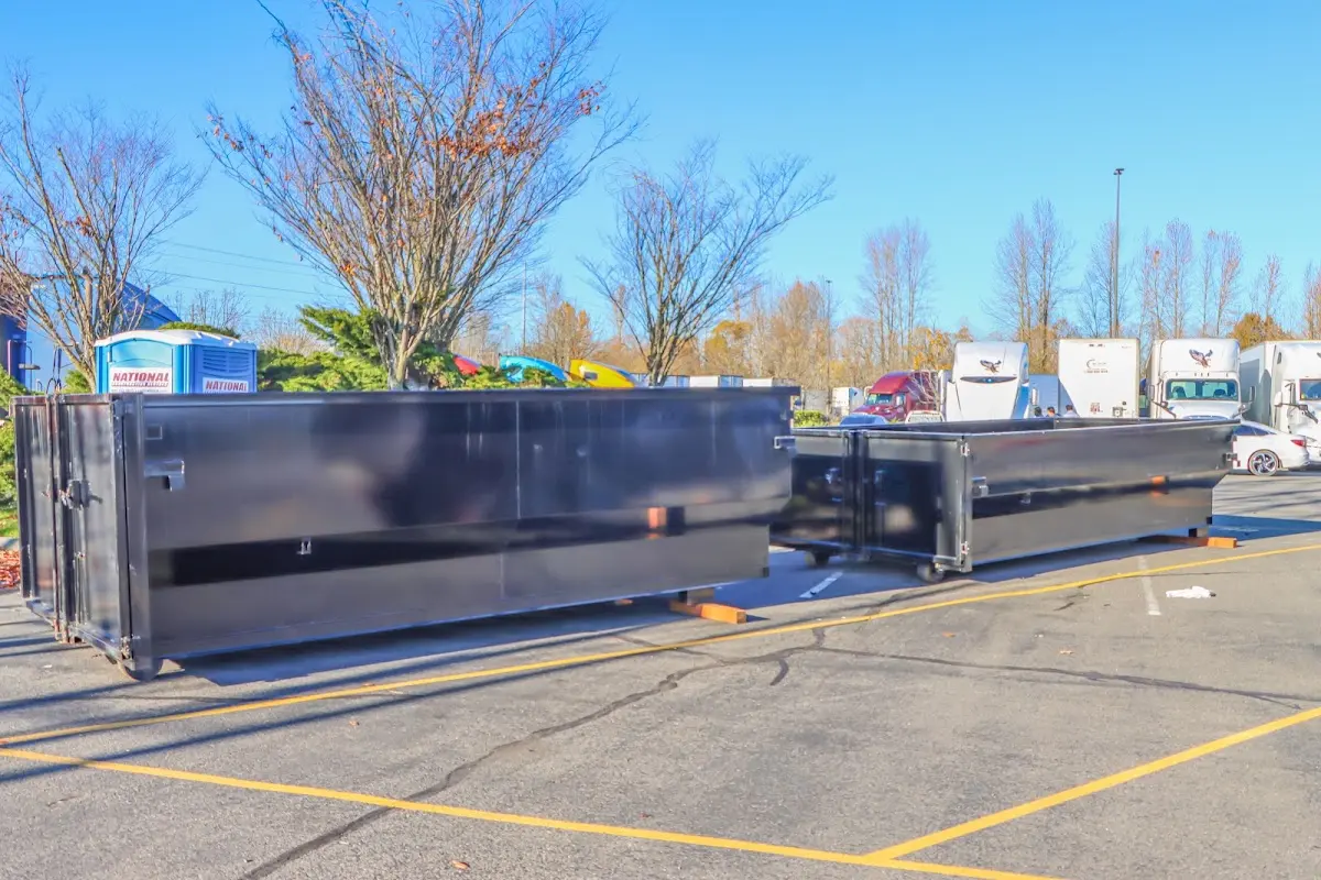 Professional dumpster rental service with roll-off container on residential driveway in Merritt Island